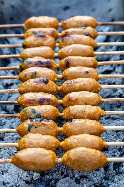 Grilled Thai sausage at street food market in Thailand Traditional Thai sausage with pork and rice delicious street food