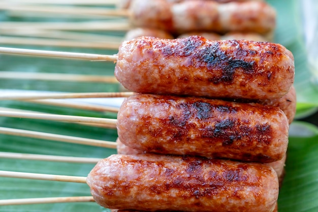 Grilled Thai sausage at street food market in Thailand Traditional Thai sausage with pork and rice delicious street food