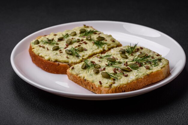 Grilled toast with avocado paste eggs cream cheese salt spices and herbs