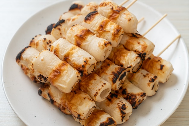 grilled tube shaped fish paste cake or tube squid skewer on plate