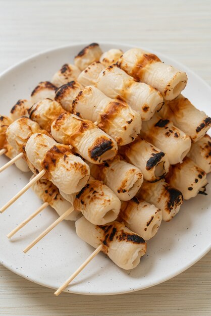 grilled tube shaped fish paste cake or tube squid skewer on plate