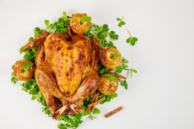 Grilled turkey garnished with caramel apples and clover leaves. Thanksgiving Day.