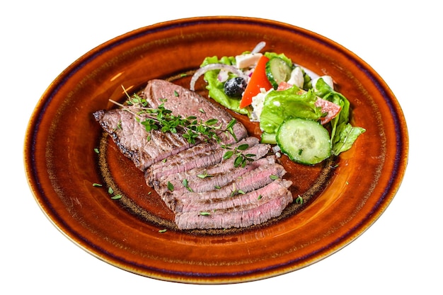 Grilled veal meat chop steak on a plate with salad Isolated on white background