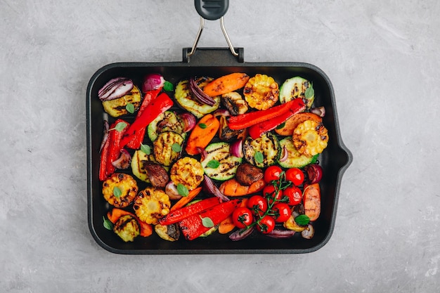 Grilled vegetables in a cast iron pan Top view copy space
