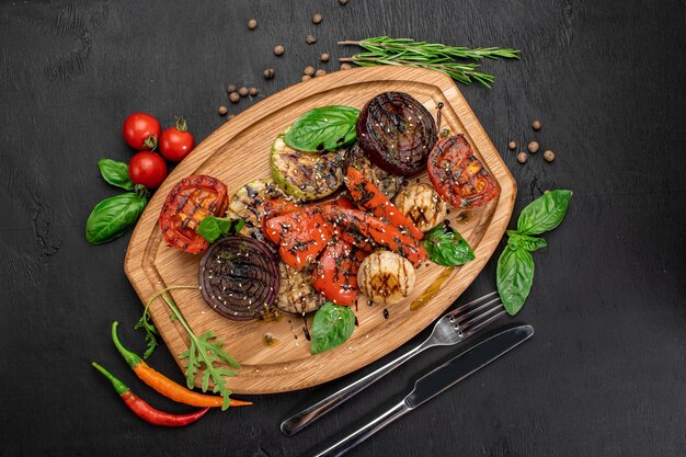 Grilled vegetables and mushrooms on wooden background