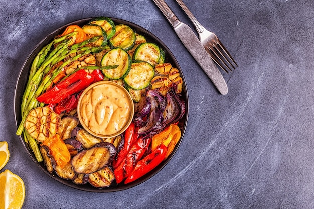 Grilled vegetables on a plate with sauce