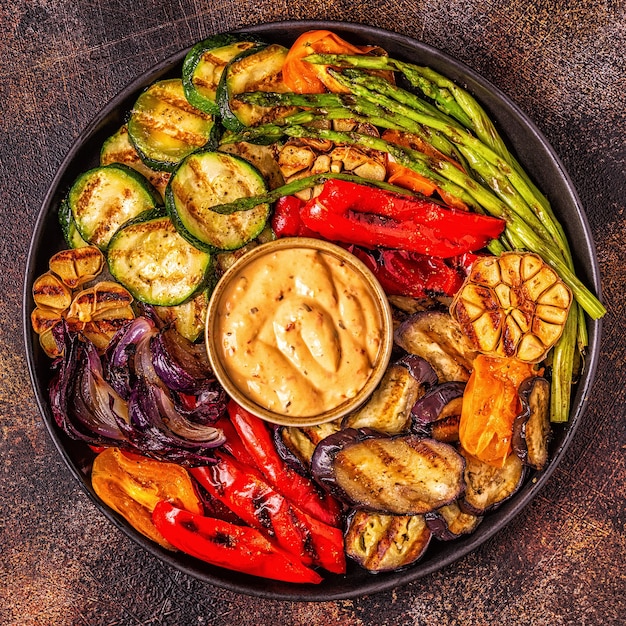 Grilled vegetables on a plate with sauce