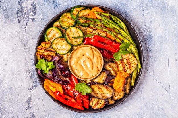 Grilled vegetables on a plate with sauce