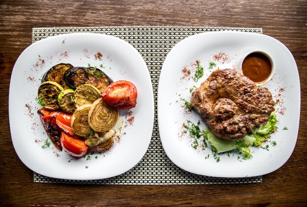 grilled vegetables with meat in a plate on a wooden table