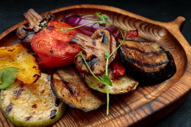 Grilled vegetables with mushrooms on a wooden board