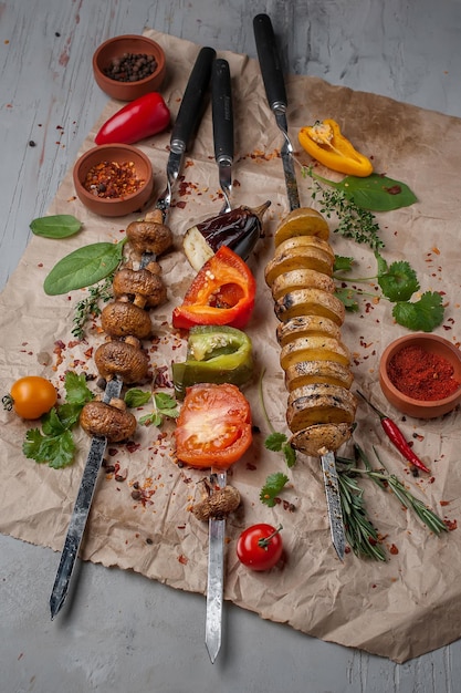 Grilled vegetables with spices for picnic bbq on craft paper
background