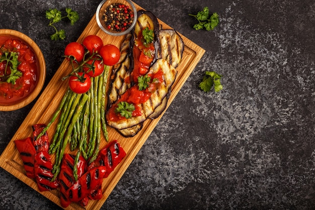 Grilled vegetables with tomato sauce and fresh herbs.