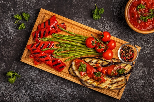 Grilled vegetables with tomato sauce and fresh herbs.