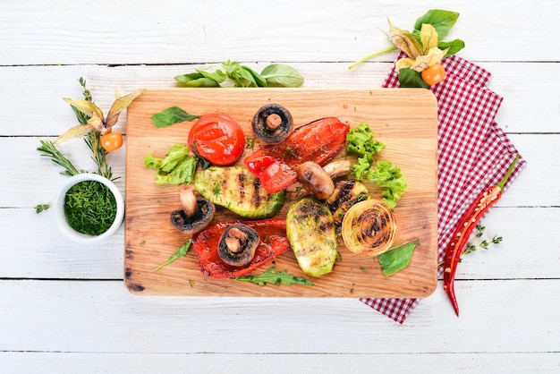 Grilled vegetables on a wooden board On a wooden background Top view Copy space