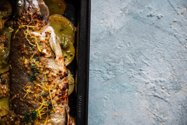 Grilled Whole Fish On Potatoes Top Down View