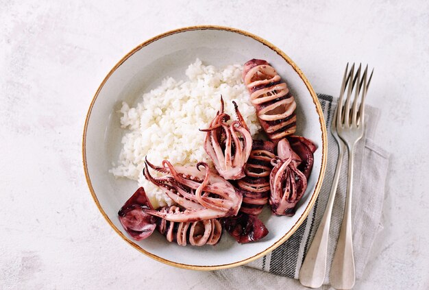 Grilled whole squids with boiled rice