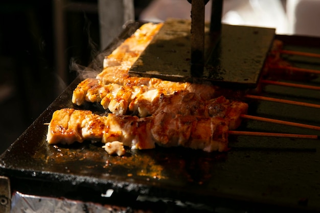 Grilled yakitori chicken skewers at an Izakaya restaurant in Omoide Yokocho street in the Shinjuku d