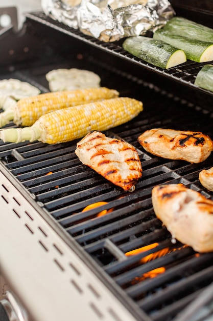 Grilling healthy dinner with organic chicken and vegetables.