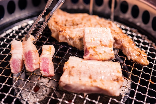 Grilling meat pork Korean BBQ traditional style on stove serve in restaurant