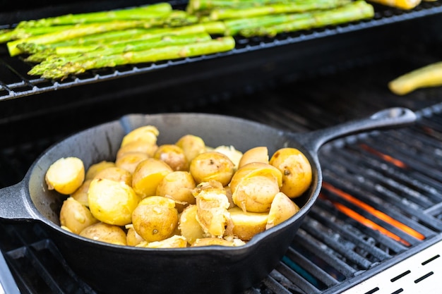 Grilling organic fresh vegetables on an outdoor gas grill in the Summer.