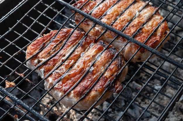 スチールグリッドの夏の休息コンセプトで豚肉を焼く