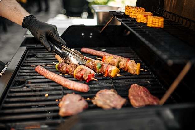 Grilling sausages and skewers on a barbecue