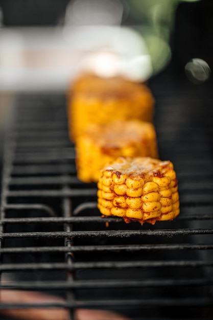 Grilling spicy pieces of corn barbecue