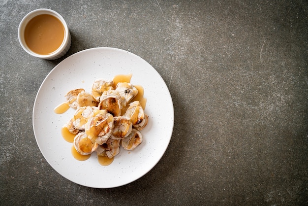 Grills in plakjes banaan met karamelsaus