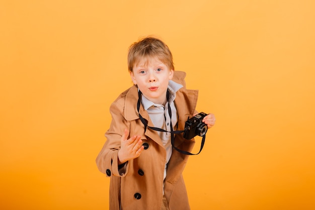 Grimacing emotional redhead fasion boy posing in a yellow studio