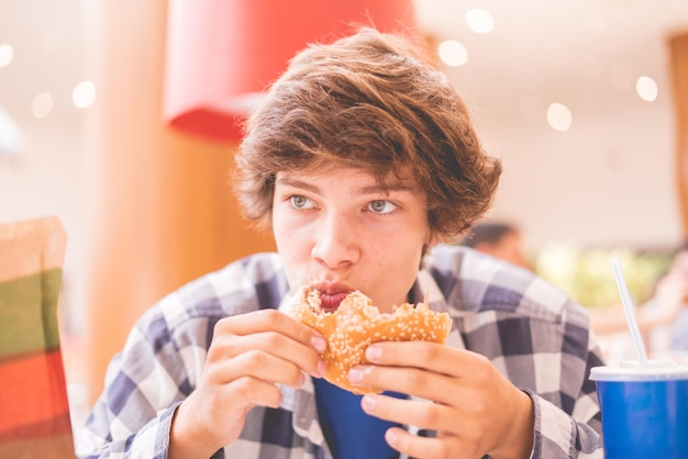 Grimy smudge funny young guy eating junk fast food