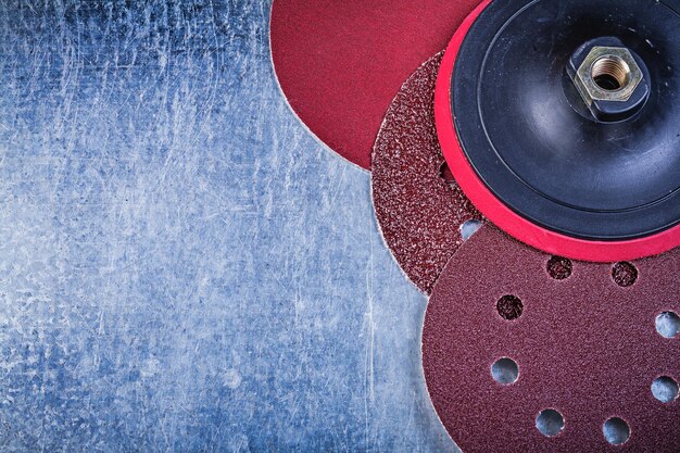 Grinding discs holder on metallic background abrasive materials.