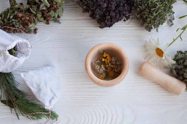 Grinding dried herbs with a mortar and pestle