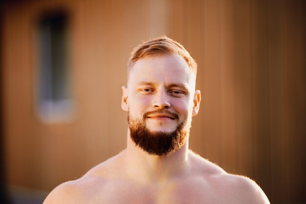 Grinning bearded face of white male in his s outdoors