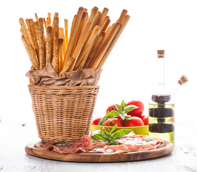 Grissini sticks and meat antipasto - italian appetizer