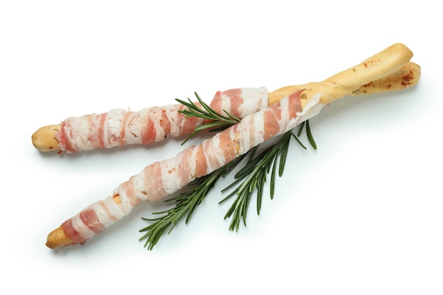 Grissini sticks with bacon isolated on white surface