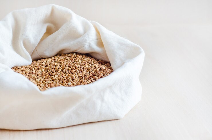 Groats, raw buckwheat porridge in bag on white wooden background, copy space. emergency ration
