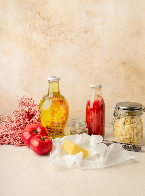 Groceries for making simple Italian pasta on kitchen table