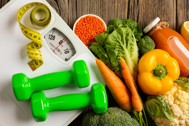 Groceries with scale on wooden table