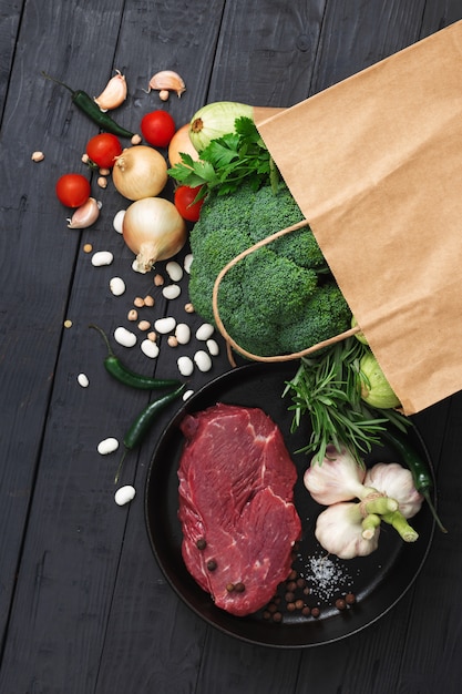 Grocery bag top view with healthy food on a wooden top view