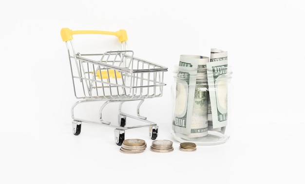 grocery cart full of cash isolated on white