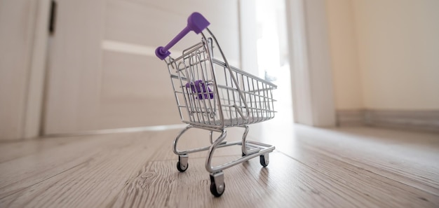 Grocery cart at the open door Delivery of products Mini trolley for contactless delivery