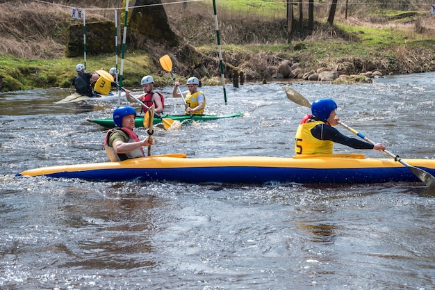 GRODNO BELARUS APRIL 2018 kayak freestyle competition on fast cold water river strenuously rowing spirit of victory