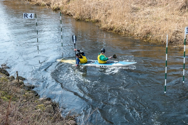 GRODNO BELARUS APRIL 2019 kayak freestyle competition on fast cold water river strenuously rowing spirit of victory