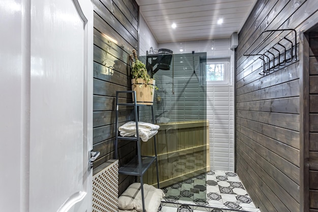 GRODNO BELARUS AUGUST 2019 toilet and detail of a corner shower cabin with wall mount shower attachment in Russian sauna in vacation house