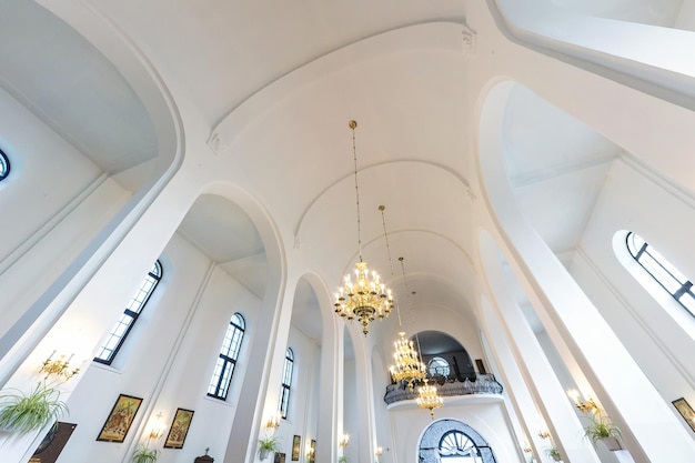 GRODNO BELARUS AUGUST 2022 dome and altar of catholic church with arches and columns ceiling and vaulting with fresco