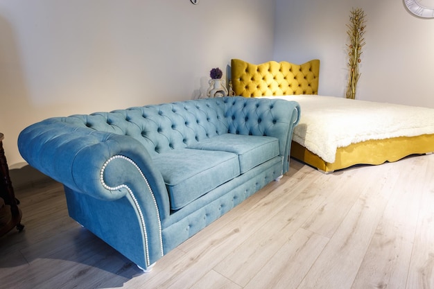 Grodno belarus december 2018 blue fabric sofa and bed in
chester style for elite loft interior in expensive store showroom
of furniture