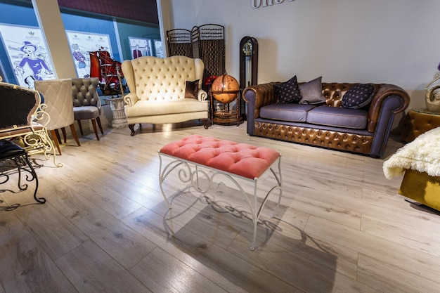 GRODNO BELARUS DECEMBER 2018 leather sofa and bench in chester style for elite loft interior in expensive store showroom of furniture