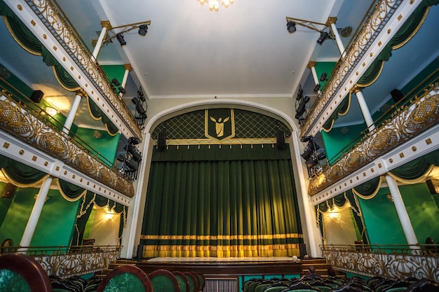 GRODNO BELARUS JULY 2018 Interior of conference concert hall or theatre with scene and green seats