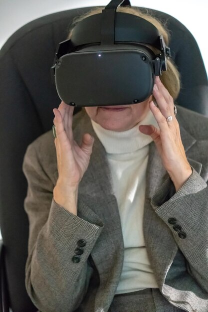 Grodno belarus june 012020 an adult woman wearing virtual\
reality glasses using vr technologies in everyday life introduction\
of augmented reality science and technology of the future in\
life