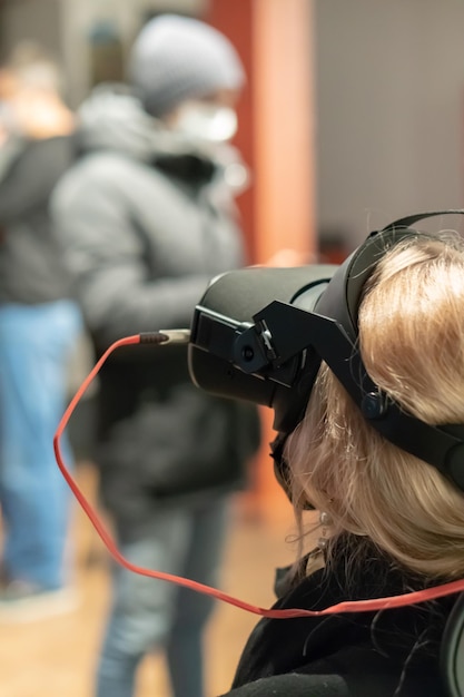 Grodno belarus june 012020 young girl in a virtual reality\
glasses using vr technologies in everyday life introduction of\
augmented reality science and technology of the future in life